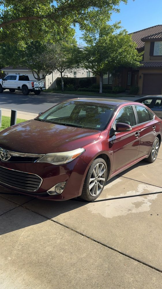Toyota Avalon with dull, spotted paint before the wash