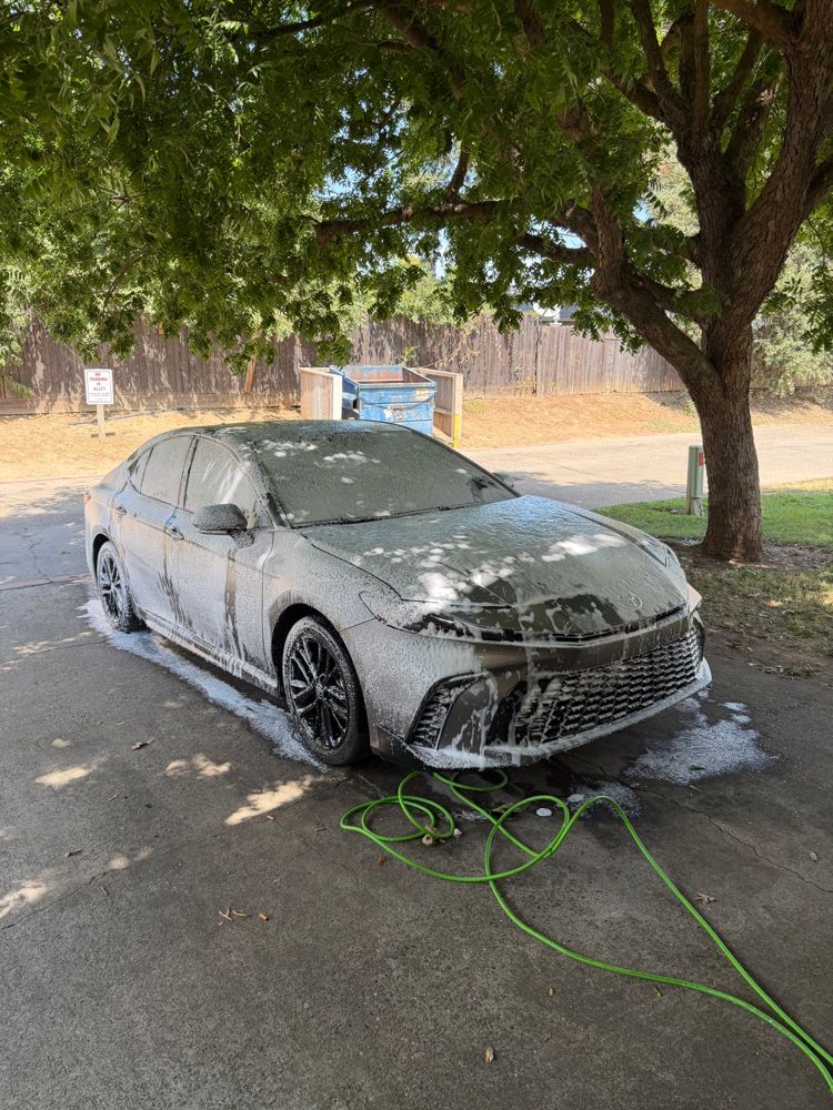Toyota sedan covered in foam during a wash