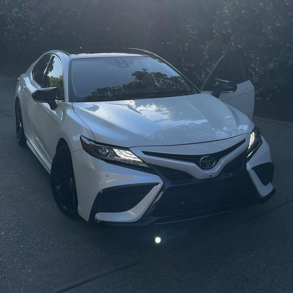 White Toyota sedan with a glossy finish