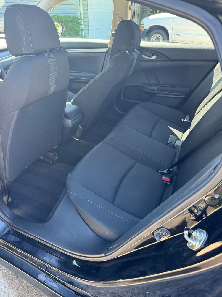Clean rear seat and carpet of a Honda sedan