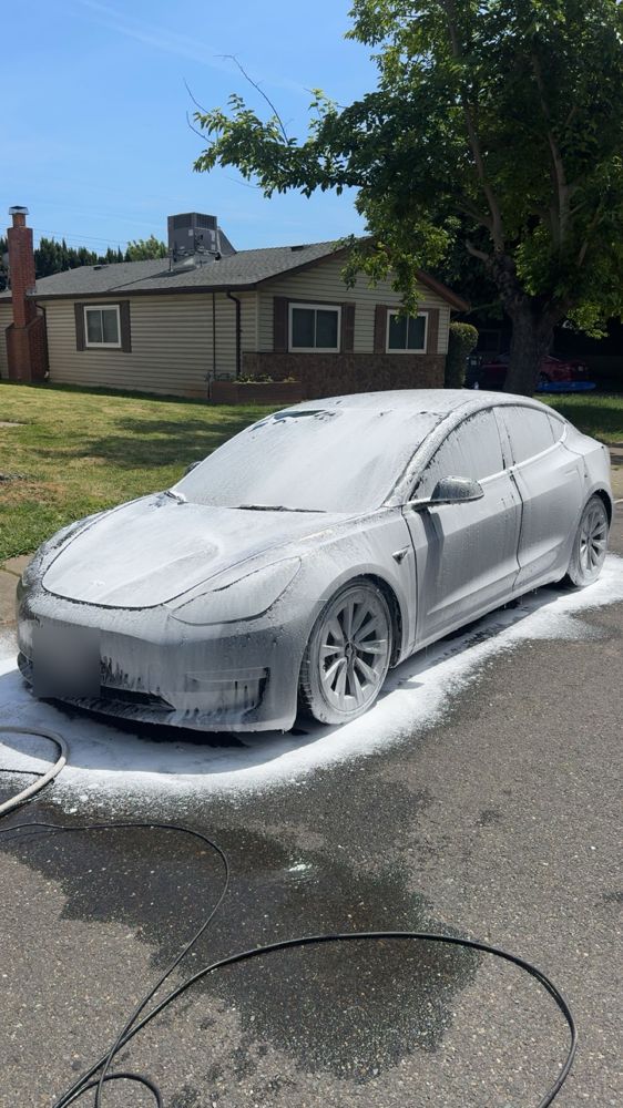Tesla covered in foam during a hand wash
