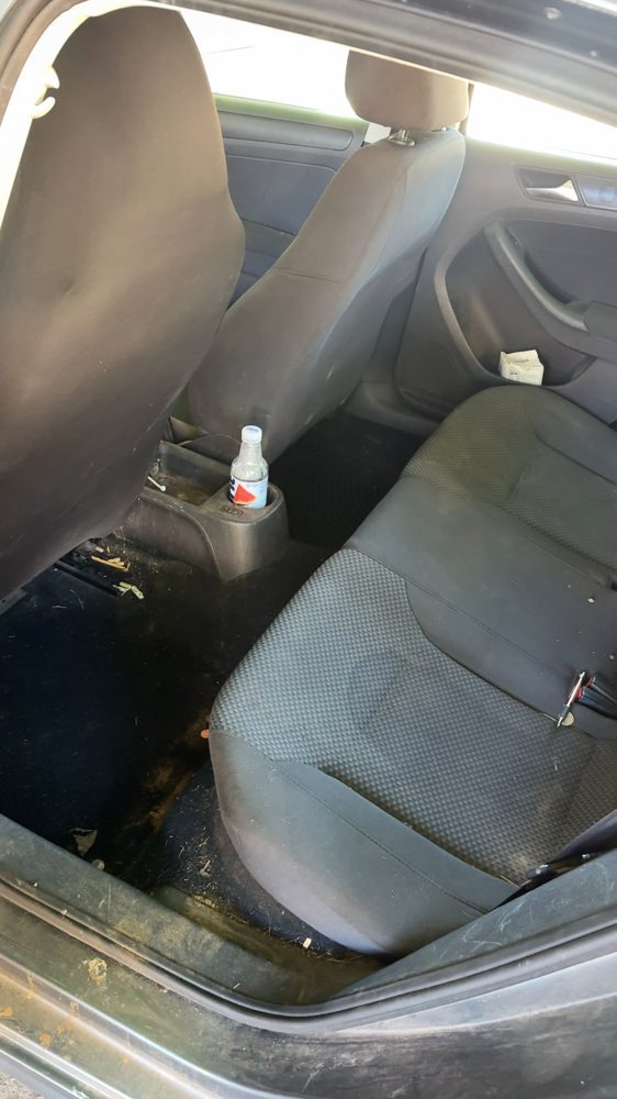 Stained rear seat of a Volkswagen before cleaning